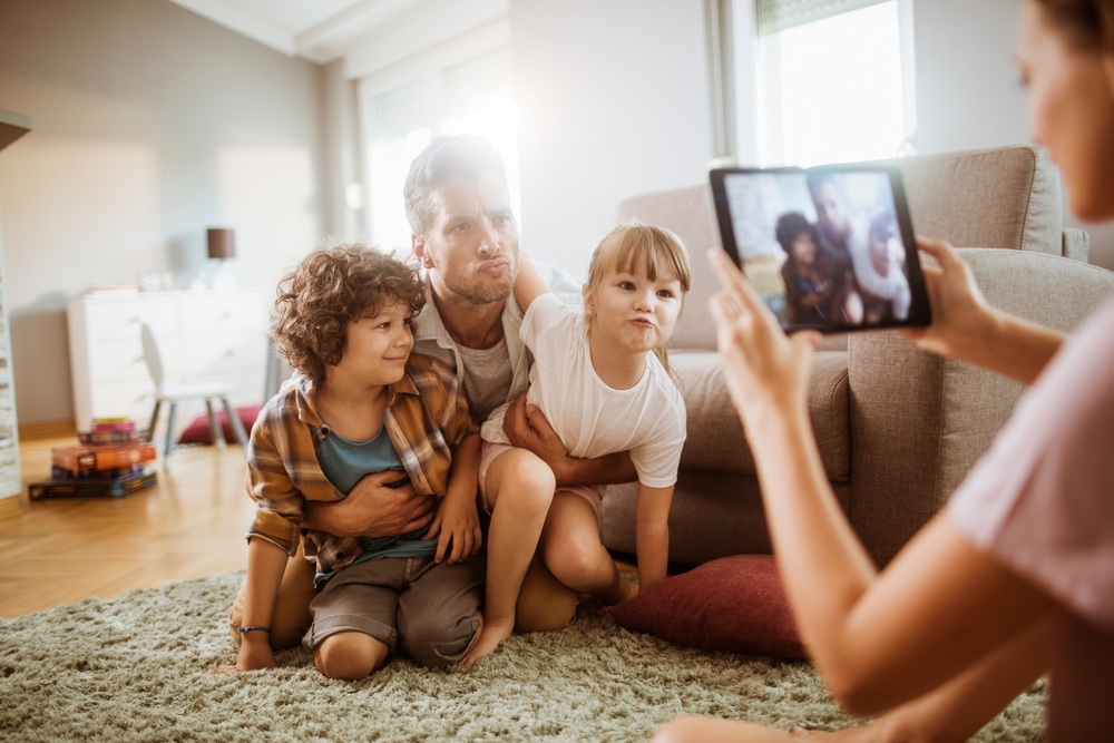 Father Making Funny Faces With Kids During A Family Photo